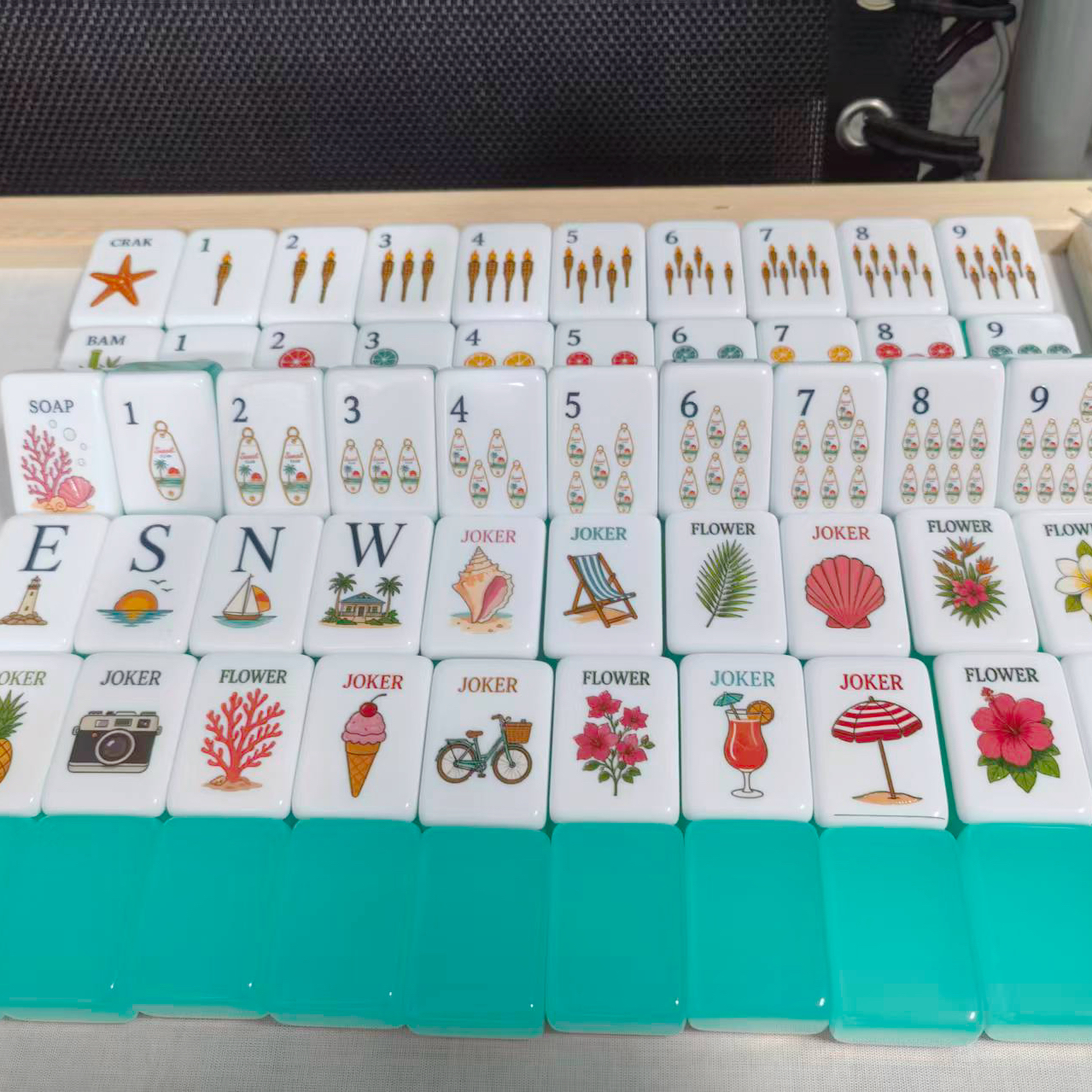 Aqua crystal-look mahjong tiles with illustrated faces