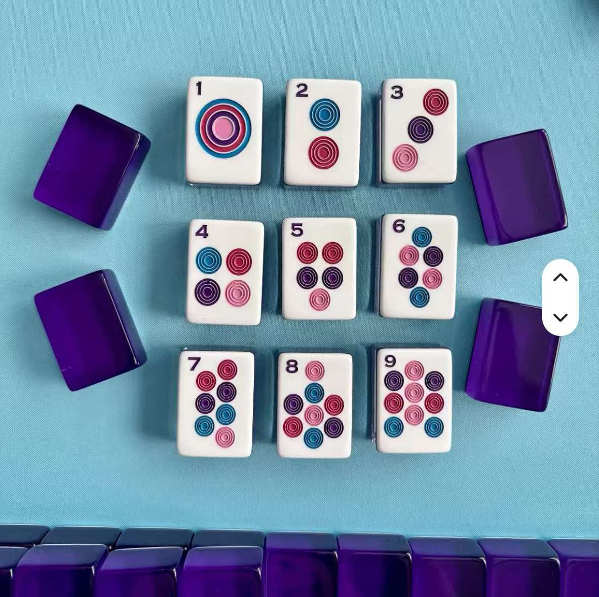 Purple-backed mahjong set on a blue playing surface
