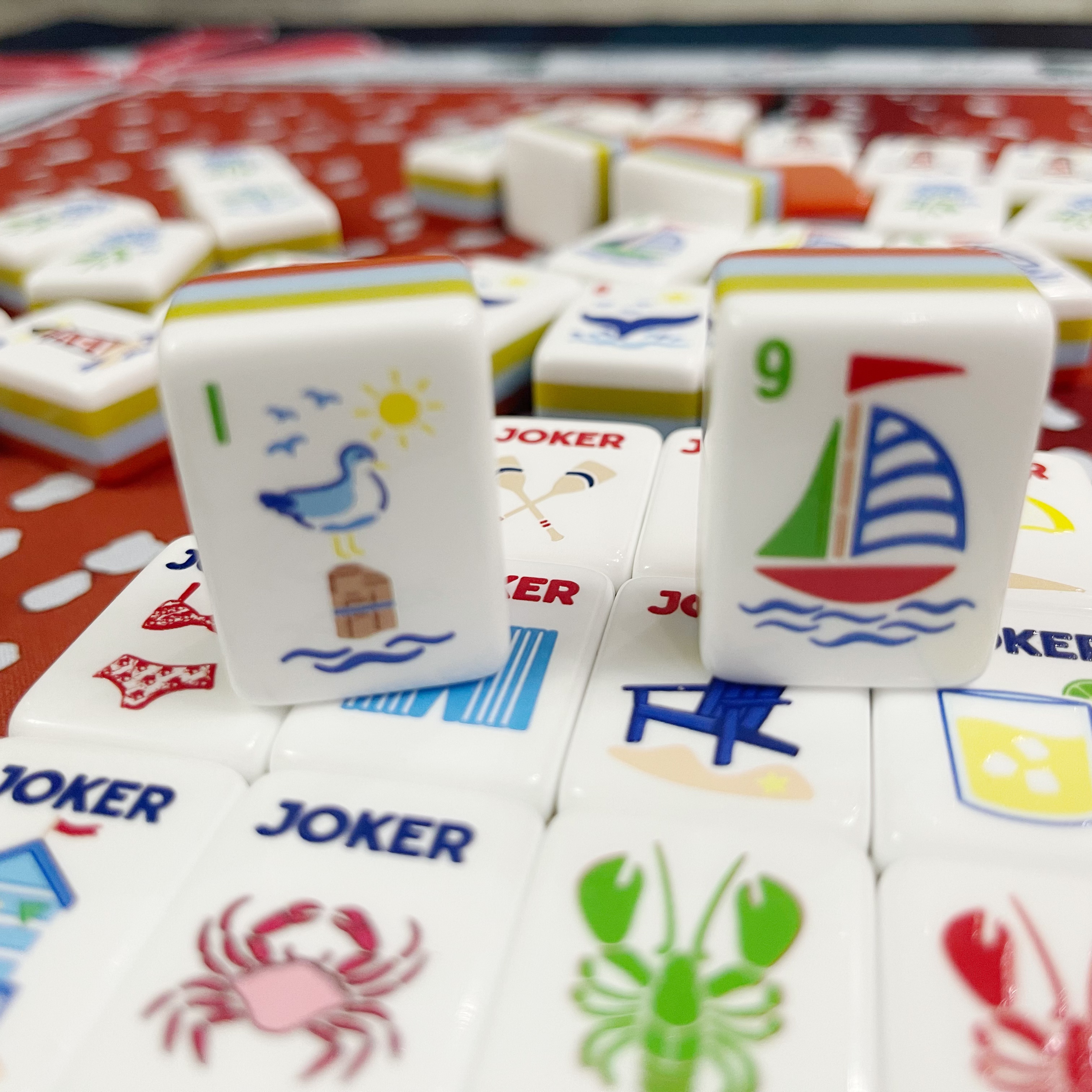 Coastal illustrated mahjong tiles with red crystal-look backs